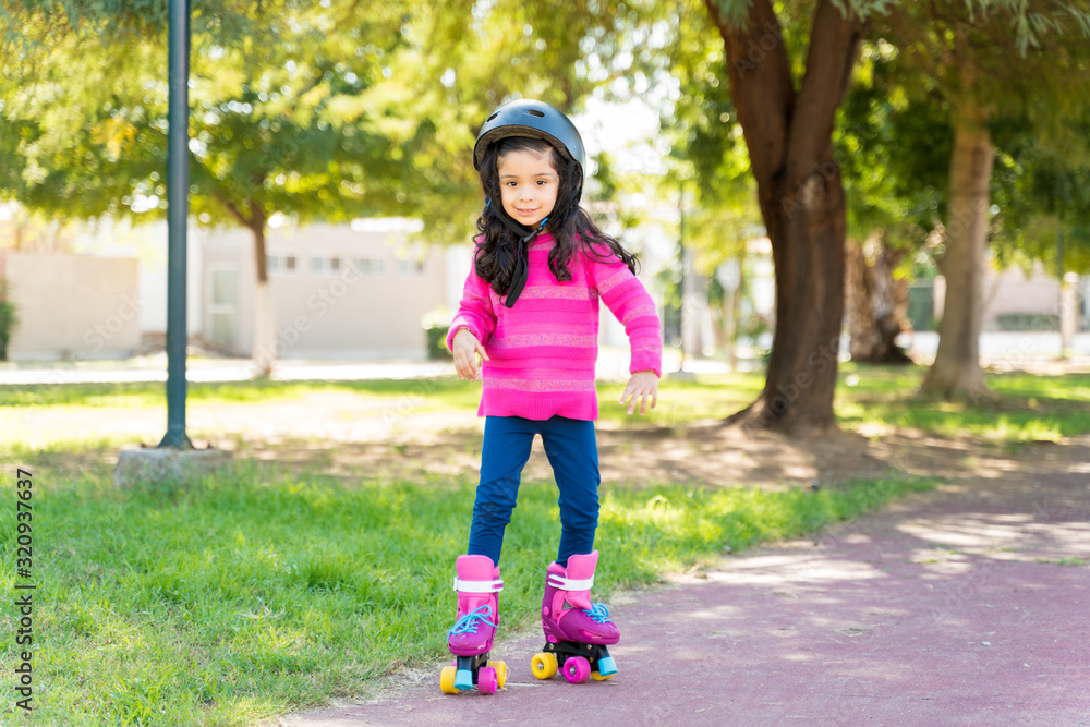 Fototapeta premium Girl Learning To Skate On Sidewalk