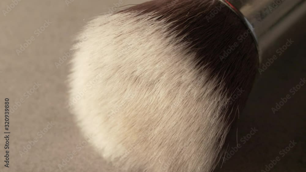 a make up brush on a concrete table closeup macro, in 4k 60p 10bit Apple ProRes422, with an external atomos recorder