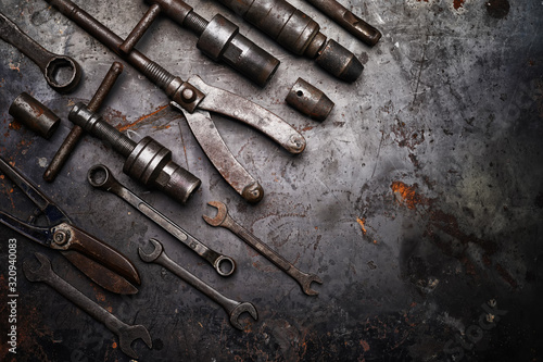Flat lay Old hand tools ,Pliers screwdriver wrench rusted iron metal tools on Steel plate at garage