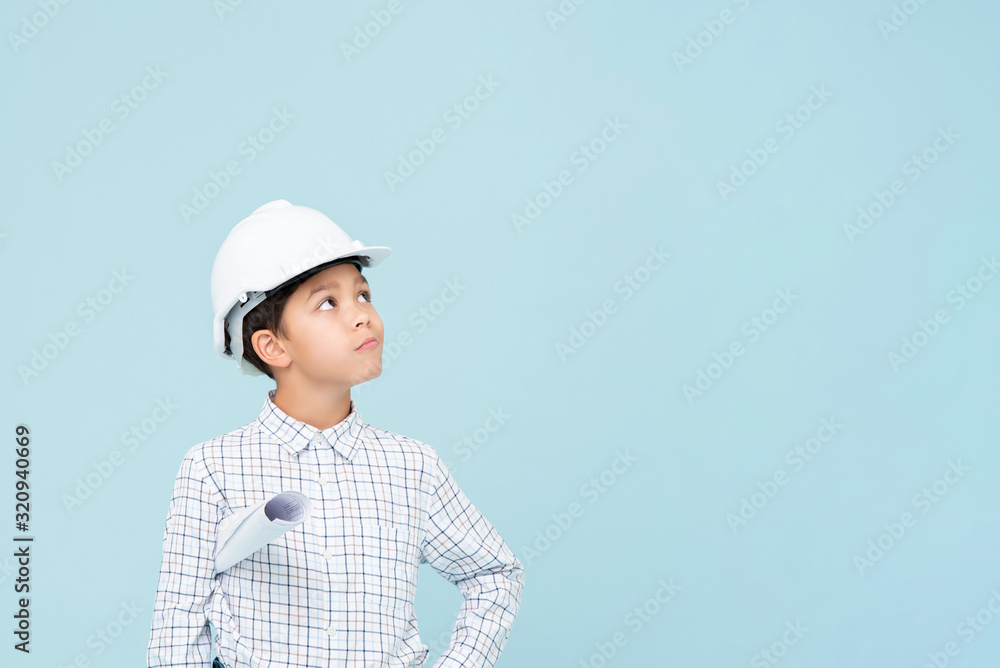 Doubt engineer boy with white helmet looking upward Doubt engineer boy with white helmet looking upward
