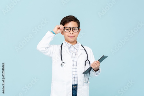 Fotografie, Tablou Smiling smart doctor boy with white medical coat and stethoscope