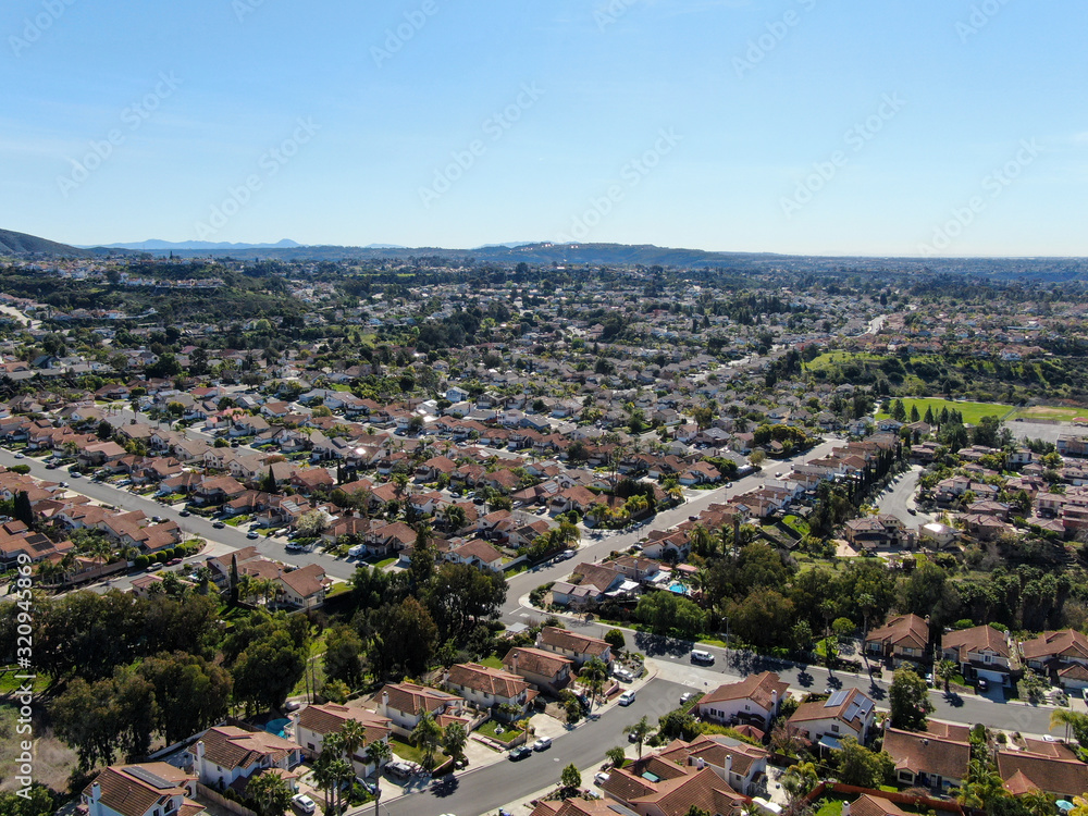 Aerial view of typical suburban neighborhood with big villas next to each other during sunny day, San Diego, California, USA. Aerial view of residential subdivision house
