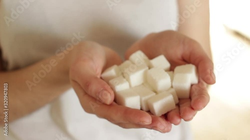 handfull of white sugar cubes on white background photo