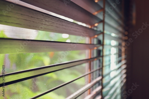 brown blind shade and mosquito wire screen on window, interior design decoration in home office