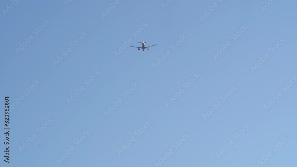 Airplane Flying Through the Blue Sky Toward Arrival at Destination Airplane Flying Through the Blue Sky Toward Arrival at Destination