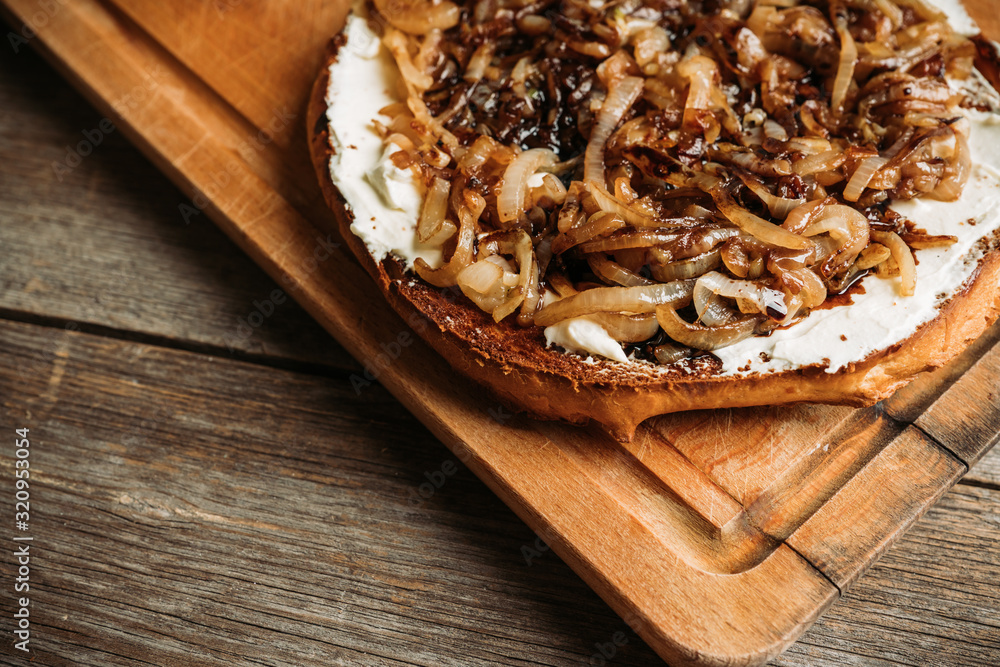 Homemade pizza with goat cheese, caramelized onion and balsamic vinegar. Selective focus. Shallow depth of field. Homemade pizza with goat cheese, caramelized onion and balsamic vinegar. Selective focus. Shallow depth of field.