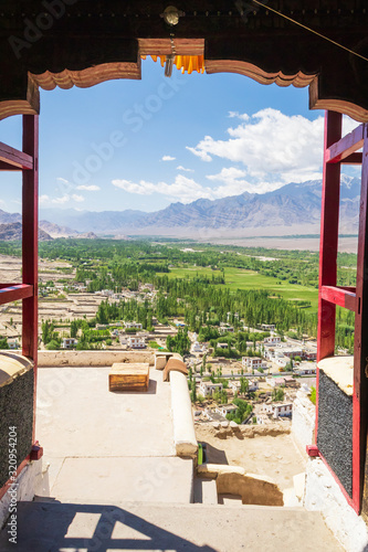 Amazing scenic view through the frame of Thiksay Monastery or Thiksay Gompa to the green valley village of the Indus river, Leh Ladakh, Jammu and Kashmir, India. photo