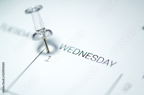 White push pin on the 1st  date of the calendar Wednesday - 1st of April Wednesday - April fools day 2020