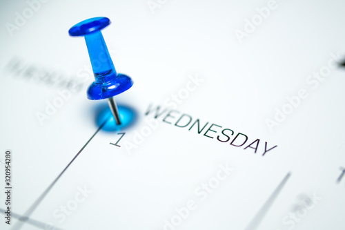 Blue push pin on the 1st date of the calendar Wednesday - 1st of April Wednesday - April fools day 2020
