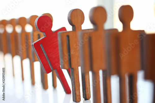 Male red plastic toy businessman silhouette wooden figure background closeup. Manipulate work recruitment transfer labour inspectorate experience exchange man hr worker subordination human concept