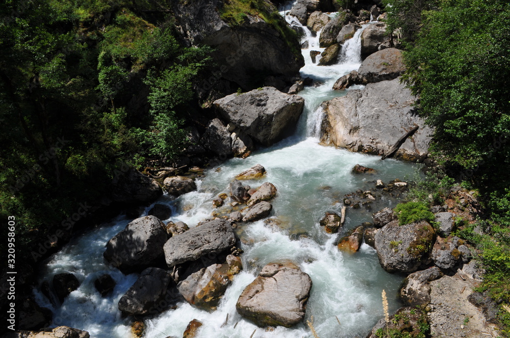 River flowing down from the mountains. River rapids and waterfalls in the mountains. River flowing down from the mountains. River rapids and waterfalls in the mountains.