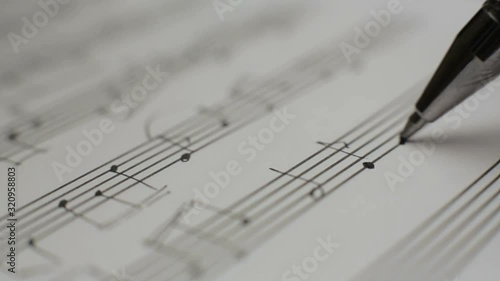Musician writes notes in the music book photo