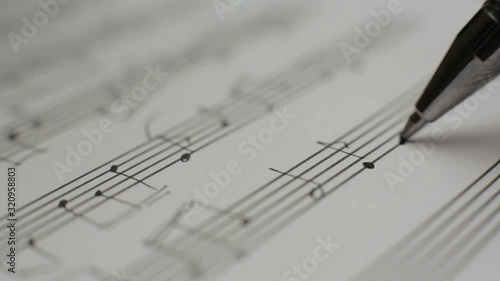 Musician writes notes in the music book