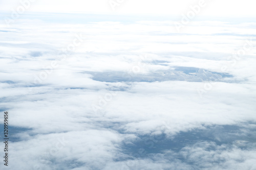 White Clouds on the bright sunny blue sky. Nature background.