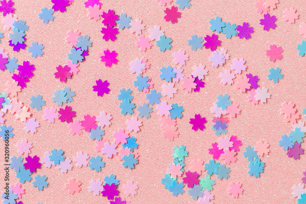 Small sakura flowers on a sparkling paper, glitter pink flowers, shimmering spring background Small sakura flowers on a sparkling paper, glitter pink flowers, shimmering spring background