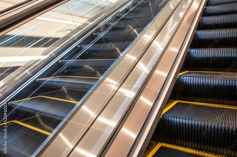 Beautiful new escalator without people in the mall close-up. Minsk Belarus 02 February 2020 Beautiful new escalator without people in the mall close-up. Minsk Belarus 02 February 2020