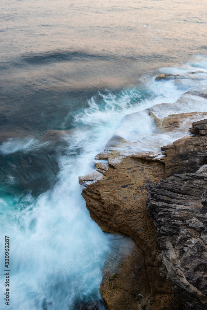 Water flowing into rocks in the coastline. Water flowing into rocks in the coastline.