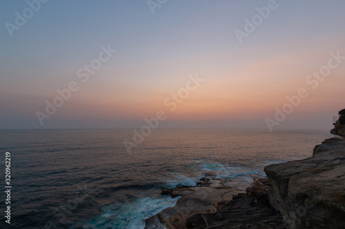 Orange sky over the ocean during sunrise.