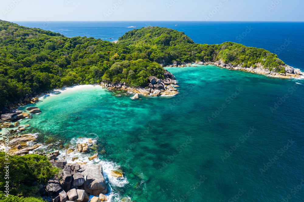 Obraz premium Aerial view drone shot ocean waves, Beautiful tropical beach and rocky coastline and beautiful forest. Nga Khin Nyo Gyee Island Myanmar. Tropical seas and islands in southern Myanmar