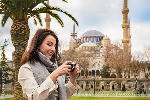 Photography Beautiful woman traveler tourist take photo with view of Sultanahmet Mosque or B