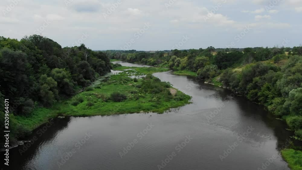 Aerial View of River With Thick Grass Patches on a Cloudy Day Tracking Forward Aerial View of River With Thick Grass Patches on a Cloudy Day Tracking Forward