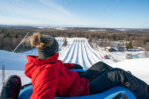 Obraz na płótnie Beautiful woman snow tubing in the winter in Canada w salonie