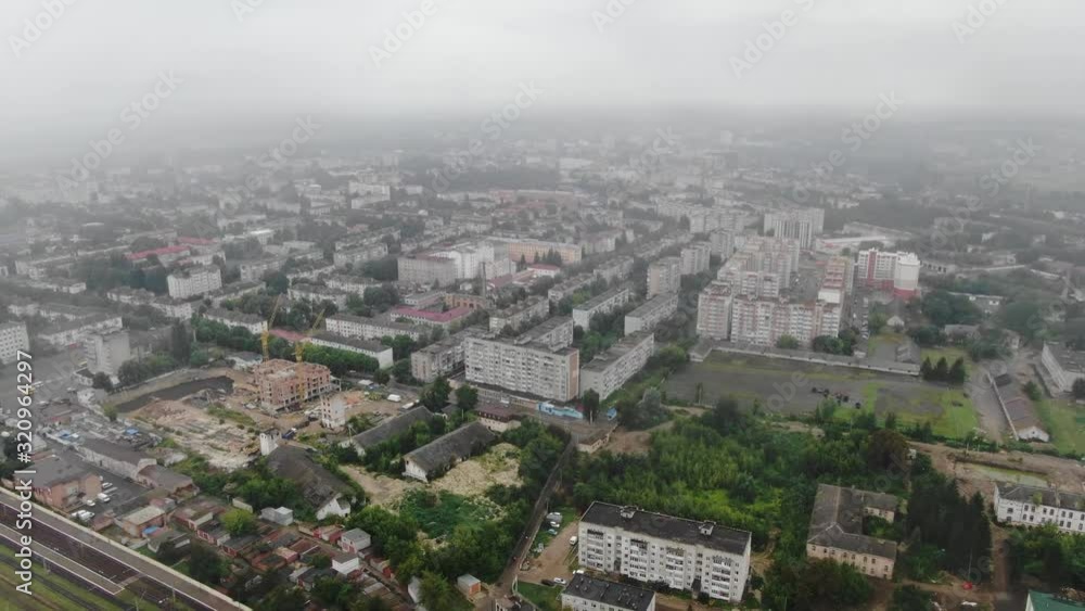 Aerial View of Buildings in a City Next to Construction Site on a Foggy Day Aerial View of Buildings in a City Next to Construction Site on a Foggy Day