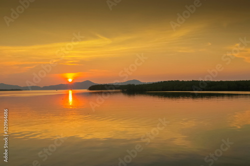 Sea view evening of sundown with yellow sun light and cloudy sky background  sunset at Kuraburi Pier  Phang Nga  southern of Thailand.