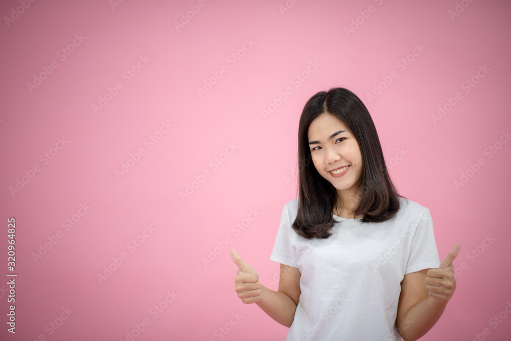 Portrait of a happy girl showing a gesture on a pink background Portrait of a happy girl showing a gesture on a pink background