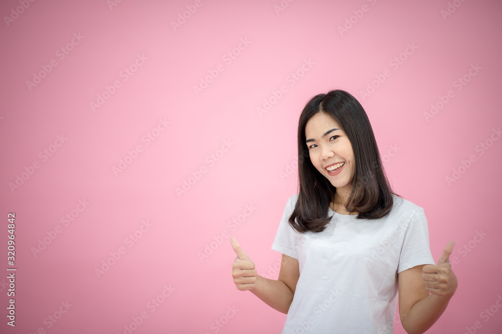 Portrait of a happy girl showing a gesture on a pink background Portrait of a happy girl showing a gesture on a pink background