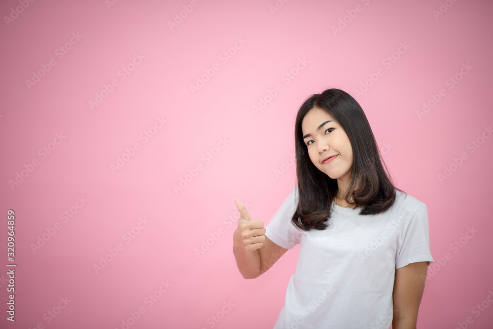 Portrait of a happy girl showing a gesture on a pink background Portrait of a happy girl showing a gesture on a pink background