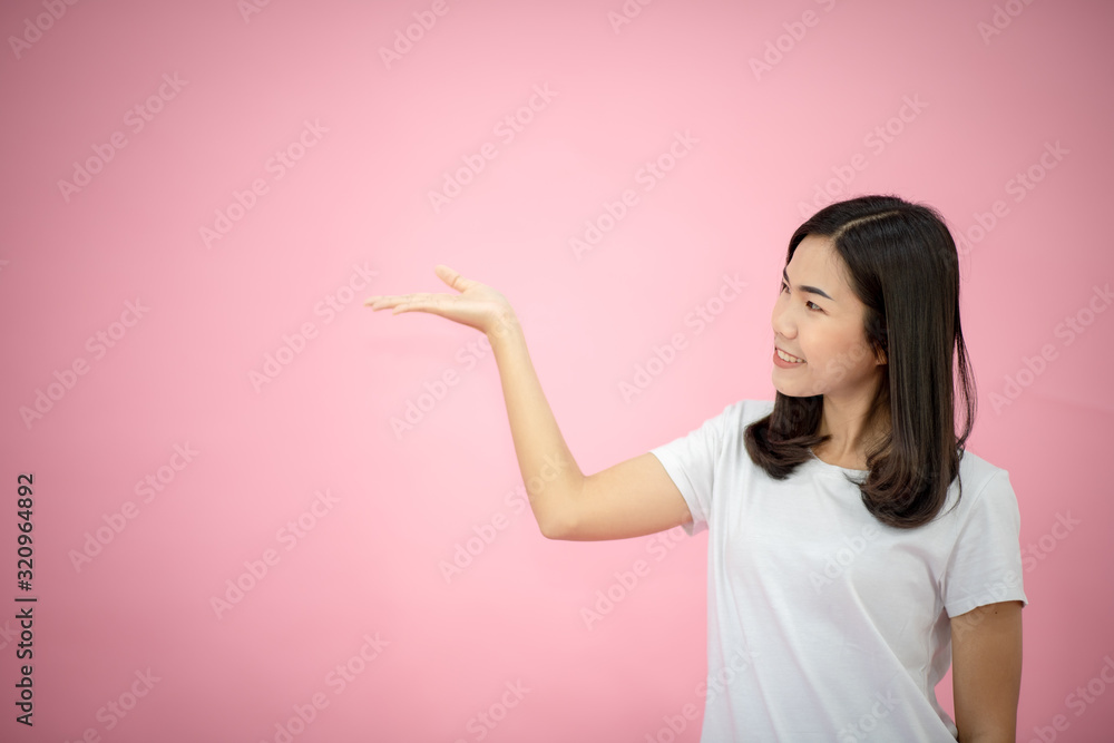 Portrait of a happy girl showing a gesture on a pink background Portrait of a happy girl showing a gesture on a pink background