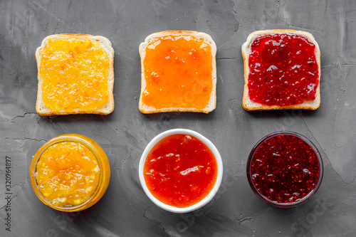Toast with jam pattern on grey background flat lay