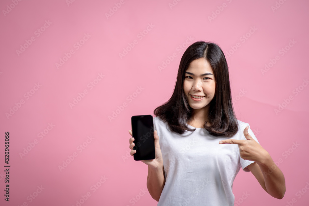 A very happy little girl with a mobile phone Photos of Asian girls wearing casual wear on pink backgrounds. Delightful emotions and concepts A very happy little girl with a mobile phone Photos of Asian girls wearing casual wear on pink backgrounds. Delightful emotions and concepts
