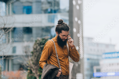 Confident stylish man talking on cellphone