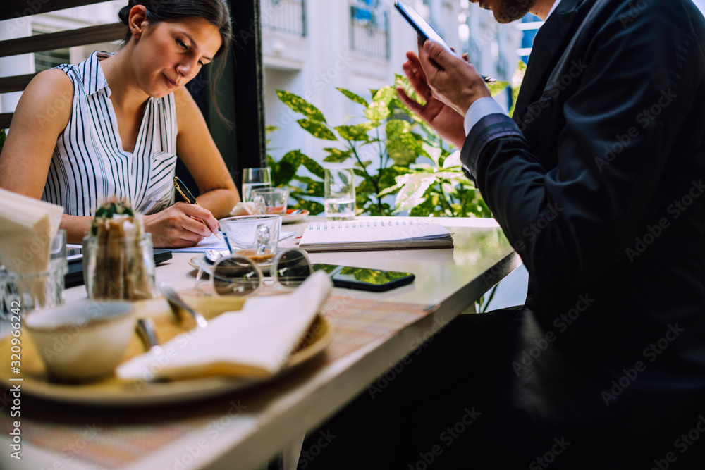 Office woman drinking coffee while writing on notebook in a restaurant Office woman drinking coffee while writing on notebook in a restaurant