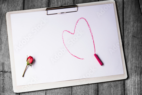 Valentines day background with heart pattern on board, write of happy valentines day text, Pink shock colour, White board, Red rose. photo