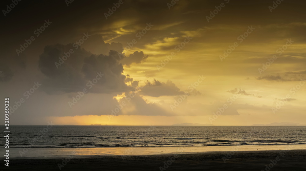 Sunset While Raining view seaside evening of soft rain and sun rays with yellow sky ...