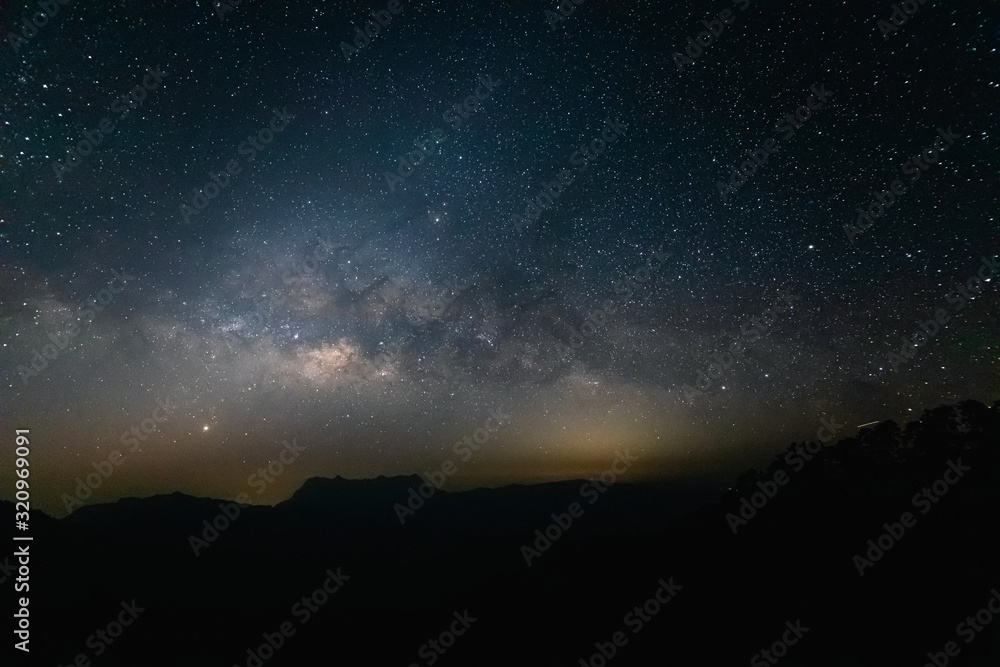 Naklejka Droga Mleczna z górskimi sylwetkami nocnego krajobrazu