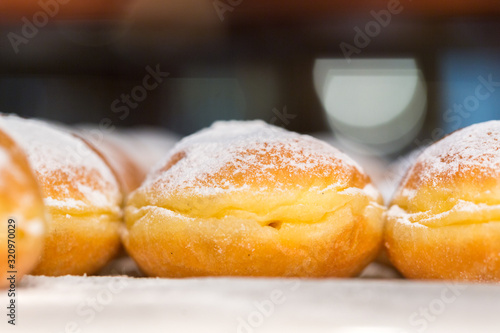Canvas Print VIENNA, AUSTRIA - January 31, 2020: Side view on doughnuts with powdered sugar on top