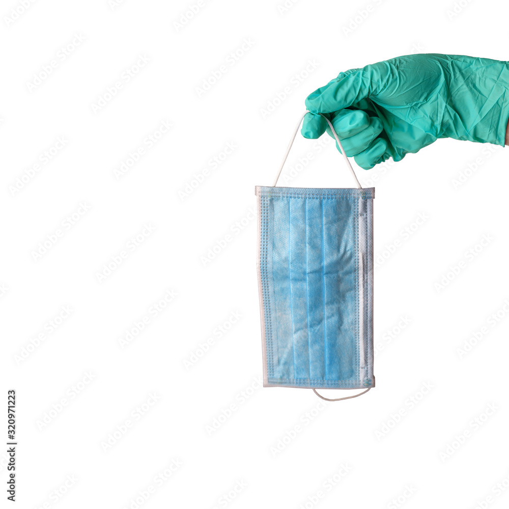 Female hand in medical glove in aqua menthe color holding protective face mask isolated on white background. Coronavirus and flu virus protection concept. Copy space. Female hand in medical glove in aqua menthe color holding protective face mask isolated on white background. Coronavirus and flu virus protection concept. Copy space.