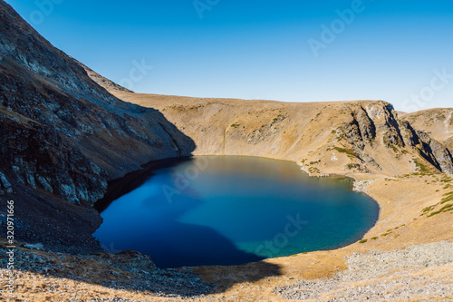 View of a blue glacial lake, one of the Seven Rila Lakes, named Okoto ("The Eye") after its almost perfectly oval form, Rila National Park, Bulgaria.