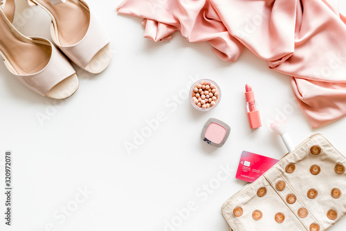 Female outfit. Clothes, shoes, cosmetics on white background top-down frame copy space