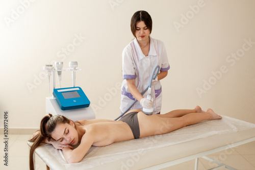 Hardware cosmetology. Body care. Spa treatment. Ultrasound cavitation body contouring treatment. Woman getting anti-cellulite and anti-fat therapy in beauty salon.
