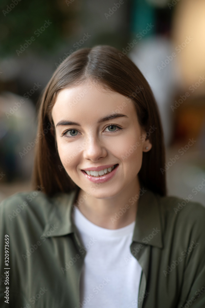 Young girl looking in front of herself smiling. Young girl looking in front of herself smiling.
