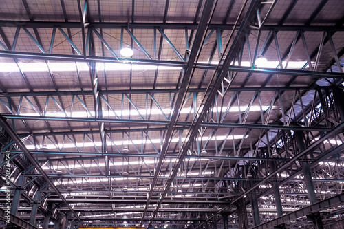 Roof steel beam structure in Industrial factory, Background of factory ceiling with one light blub, Abstract background