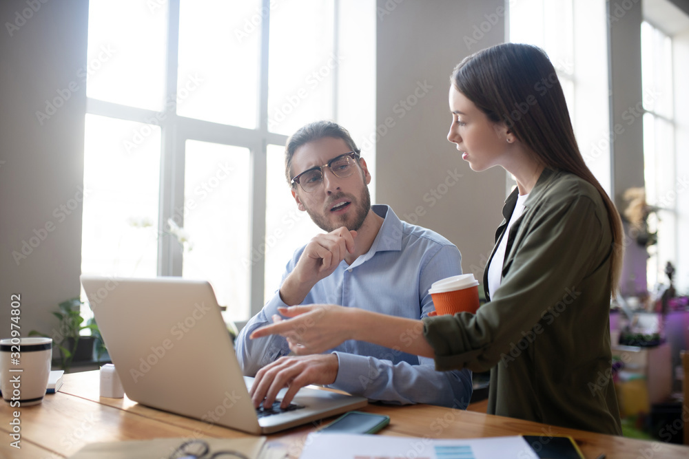 Successful girl and man discussing a joint business project. Successful girl and man discussing a joint business project.