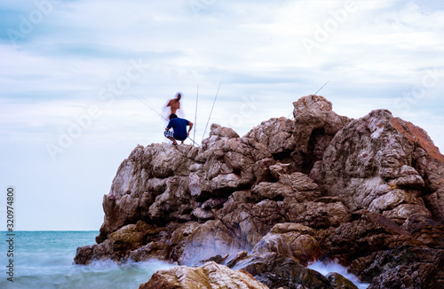 fisherman on the sea beach stones
