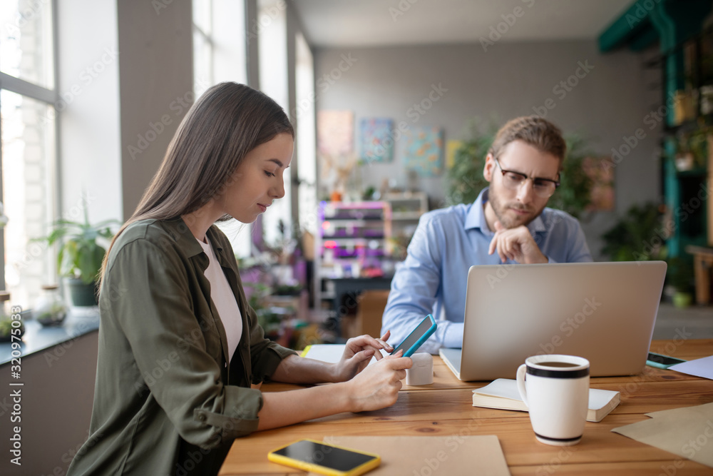 Girl with a tablet and a man at a computer. Girl with a tablet and a man at a computer.