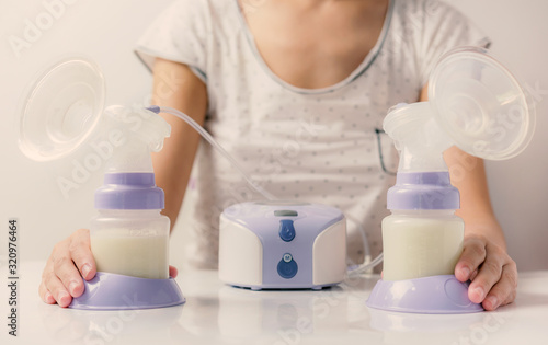 Mother holding Electric Breast Pump for Breast feeding,breast milk